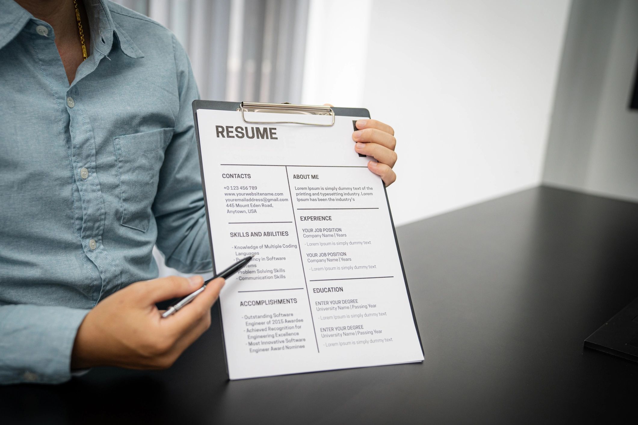 Examiner reading a resume during job interview at